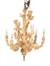 A Carved Fruitwood Ten Light Chandelier
