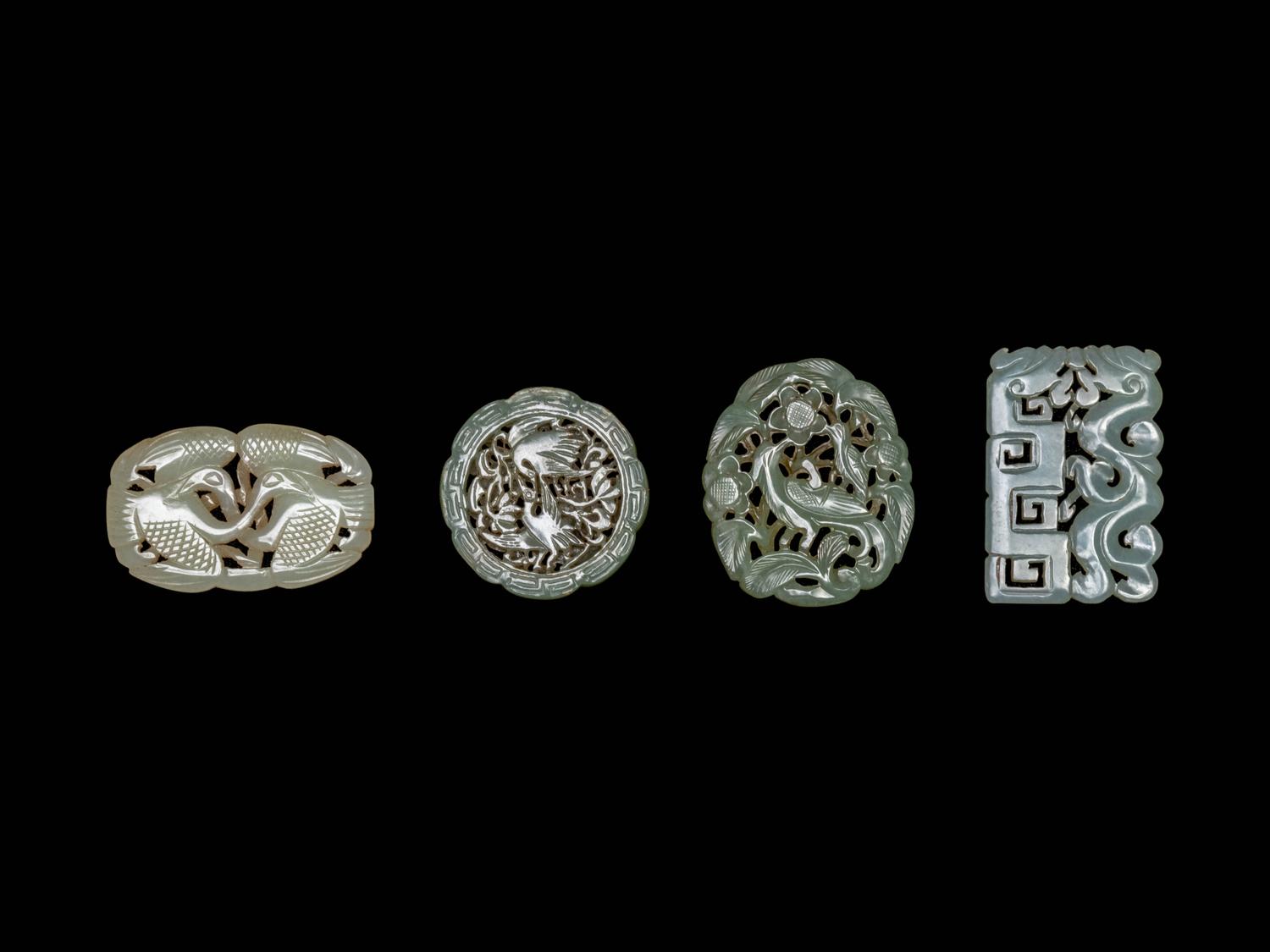 Four Chinese Celadon Jade Carved and Reticulated Pendants