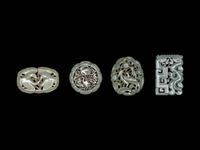 Four Chinese Celadon Jade Carved and Reticulated Pendants
