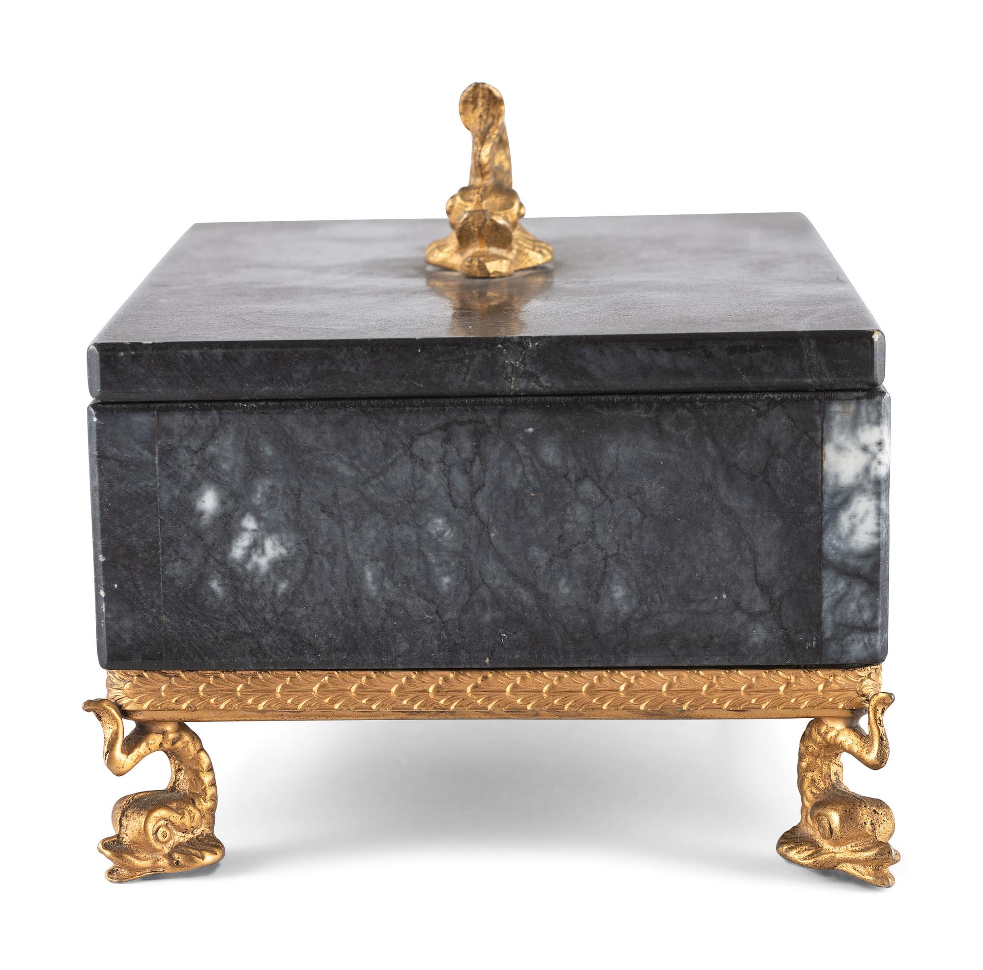 A Gilt and Black Onyx Box with Dolphin Finial