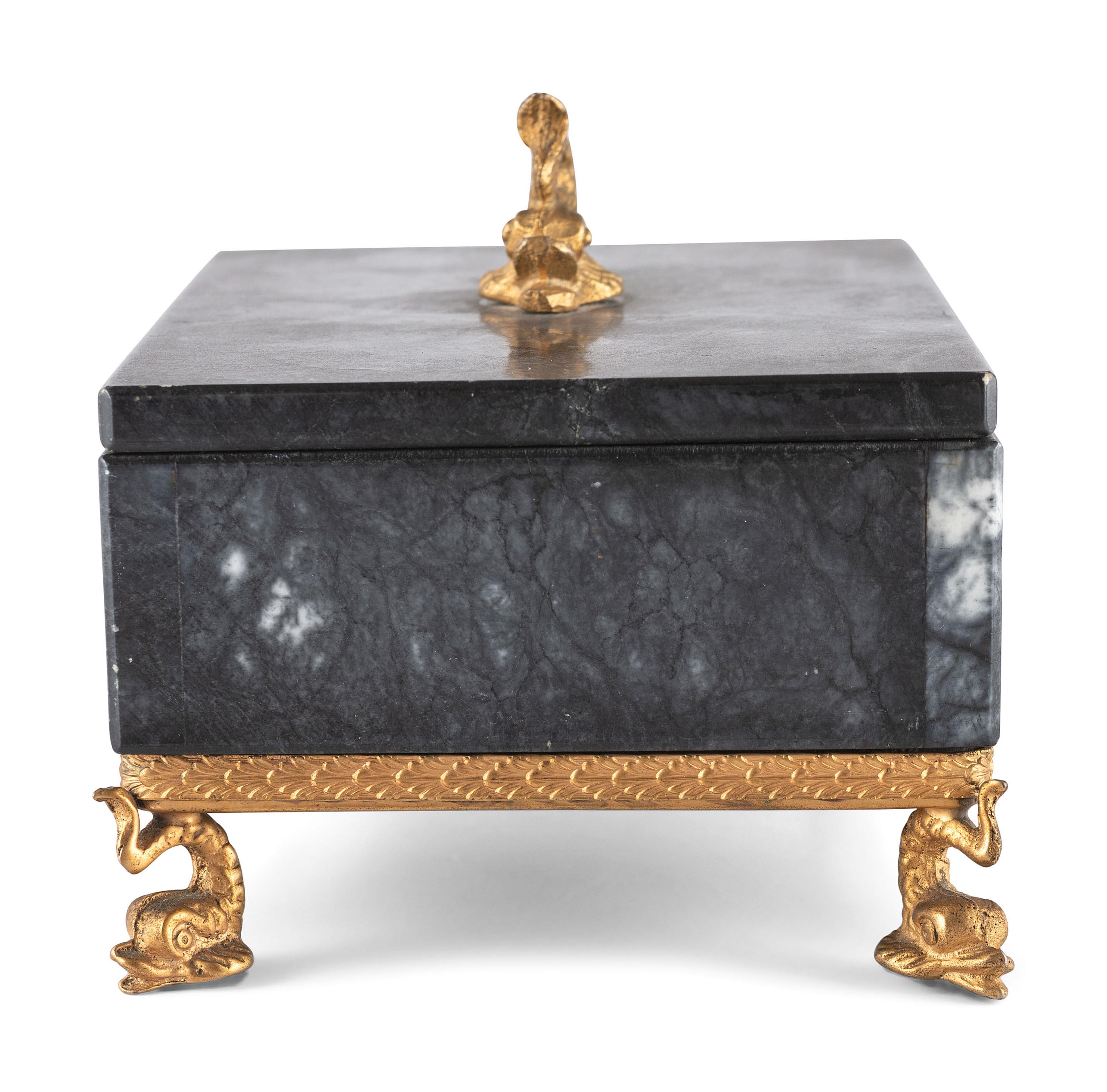 A Gilt and Black Onyx Box with Dolphin Finial