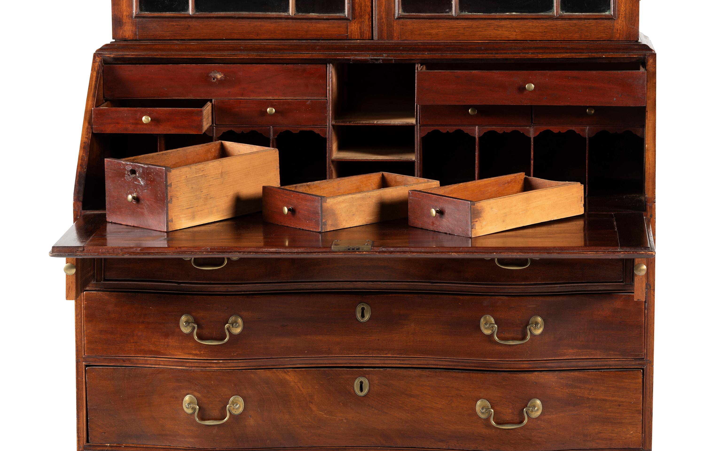 A Chippendale Mahogany and Cherrywood Serpentine Claw-and-Ball Foot Desk-and-Bookcase