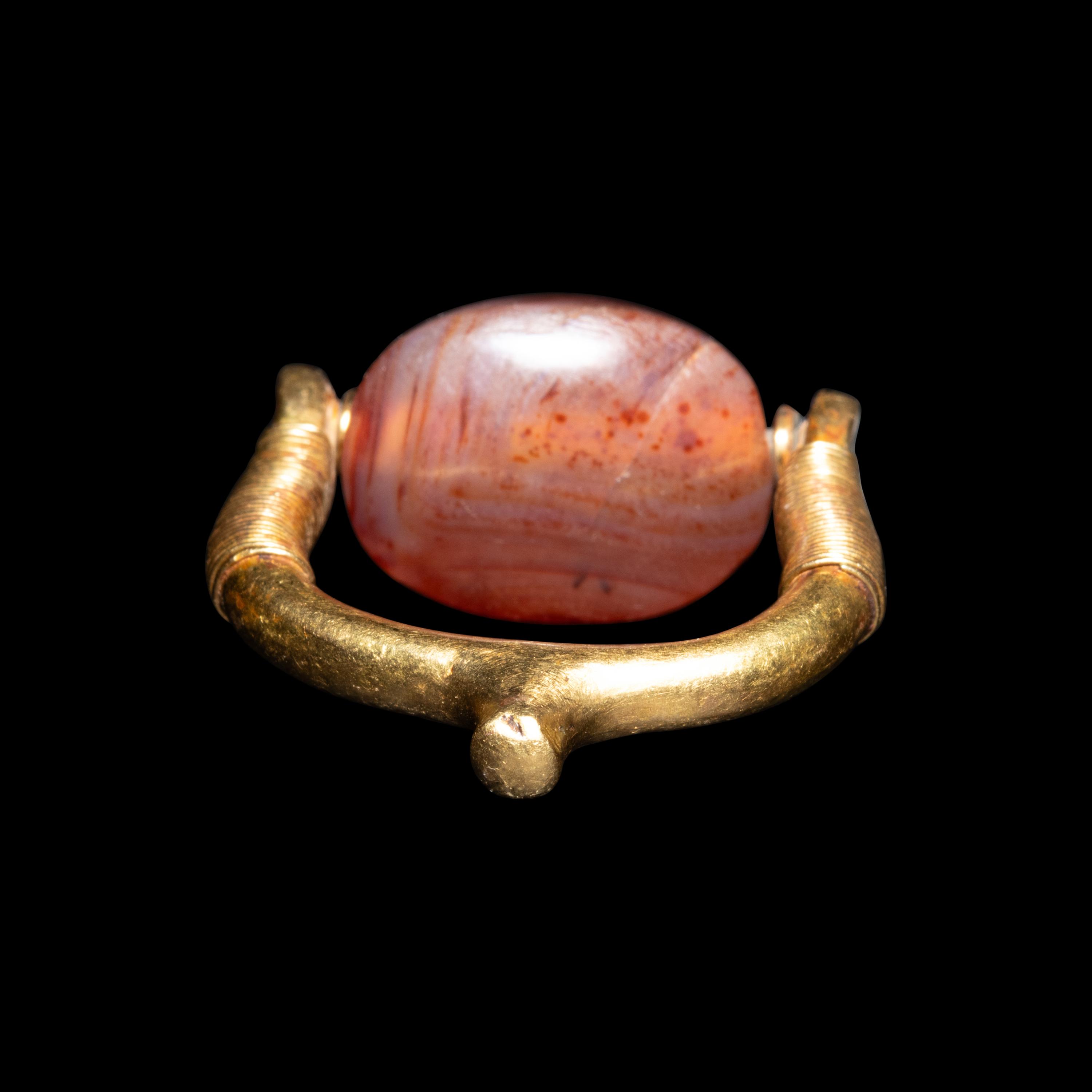 A Phoenician or Cypriot Gold and Carnelian Swivel Ring with Two Scorpions