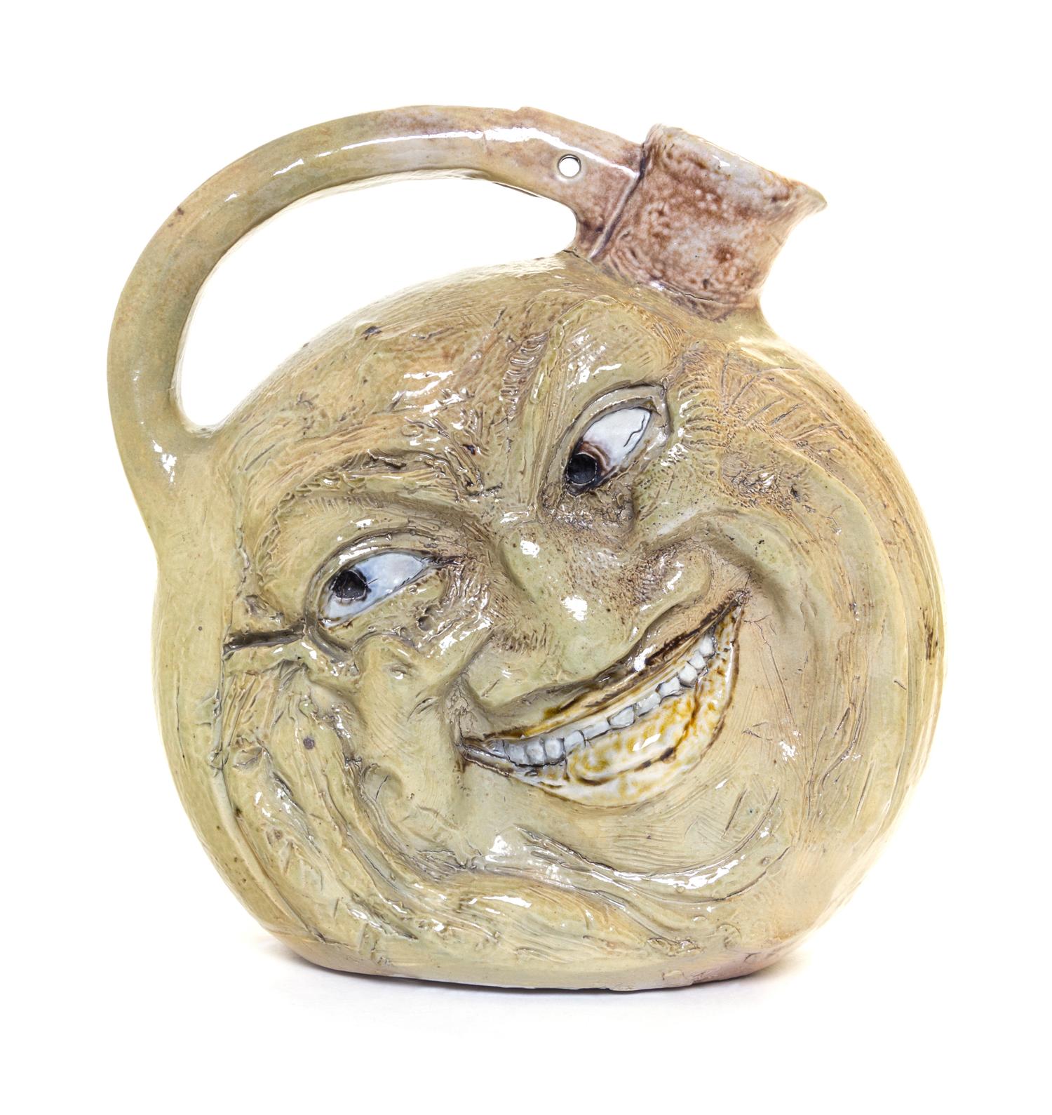 A Martin Brothers Salt Glazed Stoneware Face Jug Height 9 1/2 inches. — CIRCA 1900