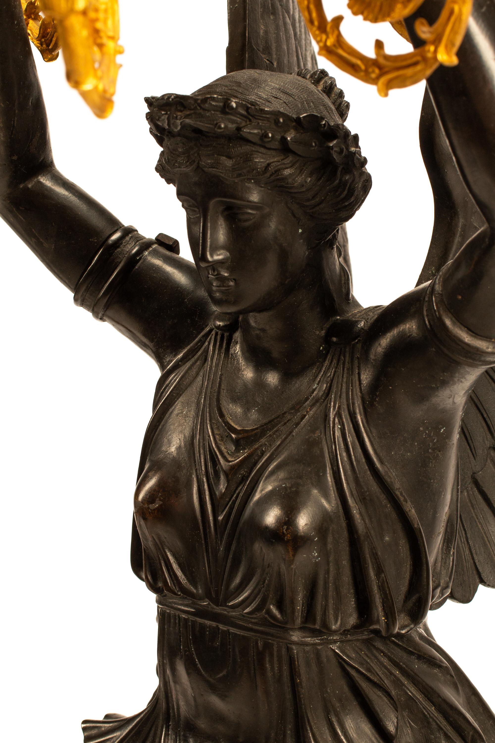 A Pair of Monumental Empire Style Gilt and Patinated Metal Seven-Light Figural Candelabra