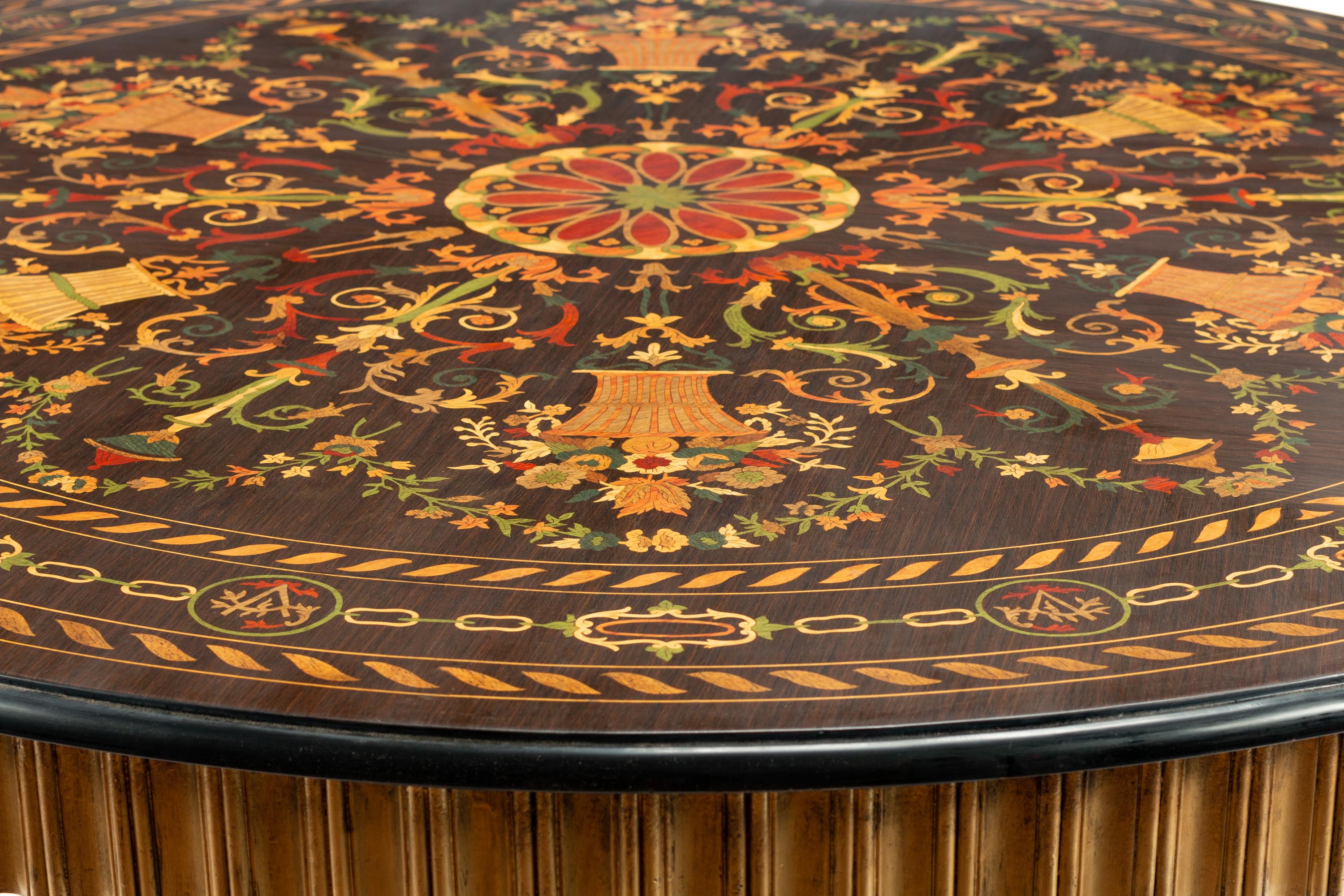 A Continental Parcel Ebonized Marquetry Center Table