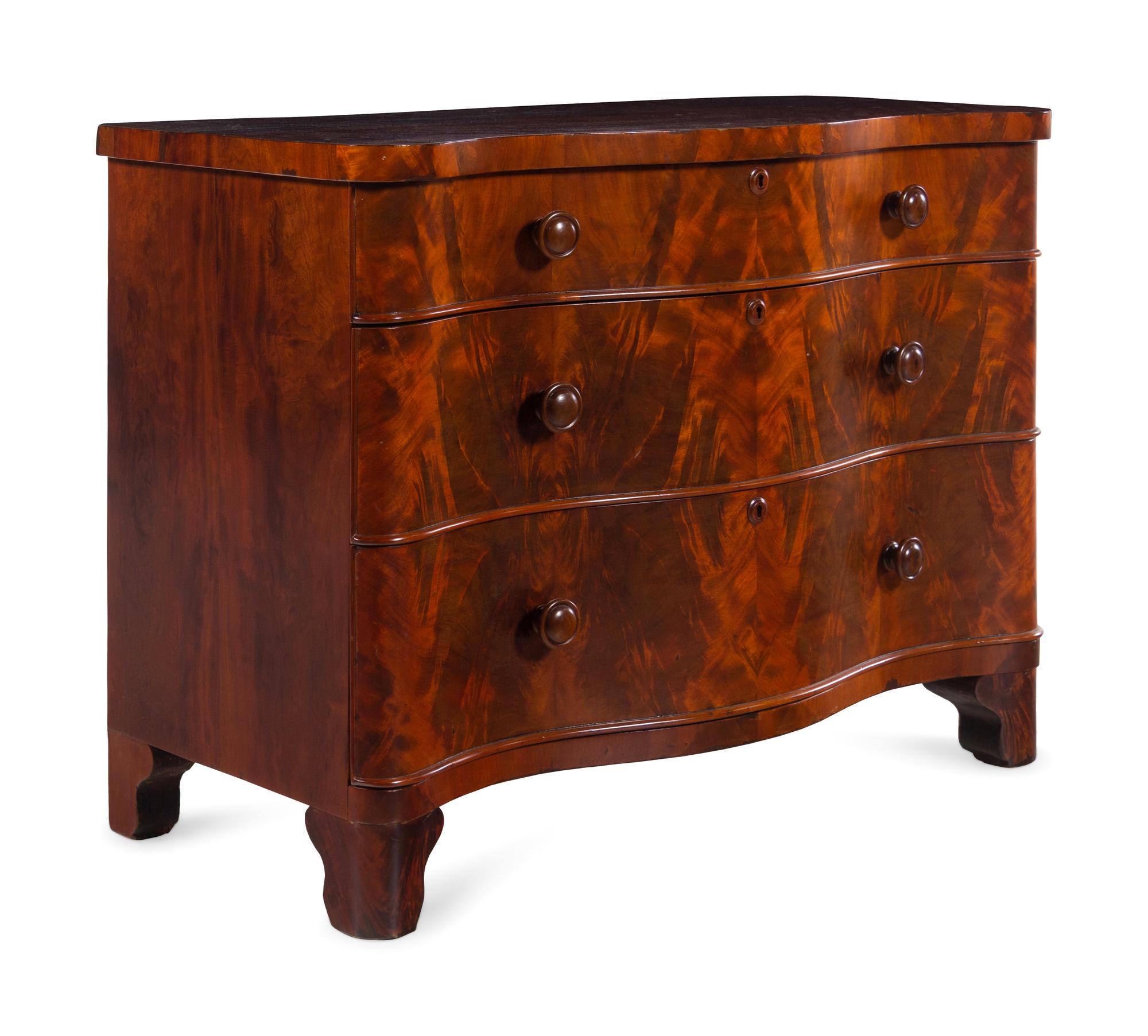 A Continental Walnut Serpentine-Front Chest of Drawers