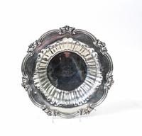 An American Silver Bowl, , of shallow circular form, the rim applied with scrolling decoration.