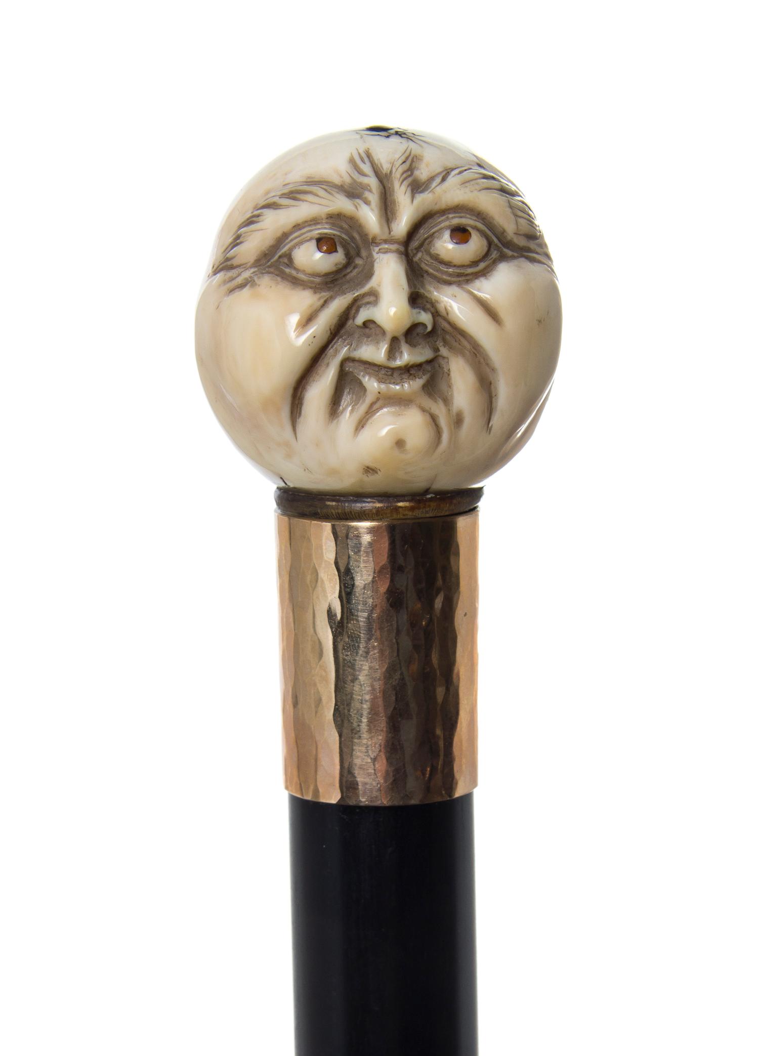 A Japanese Ivory Handled Walking Stick, Diameter of handle 1 1/2 x length overall 36 3/8 inches.