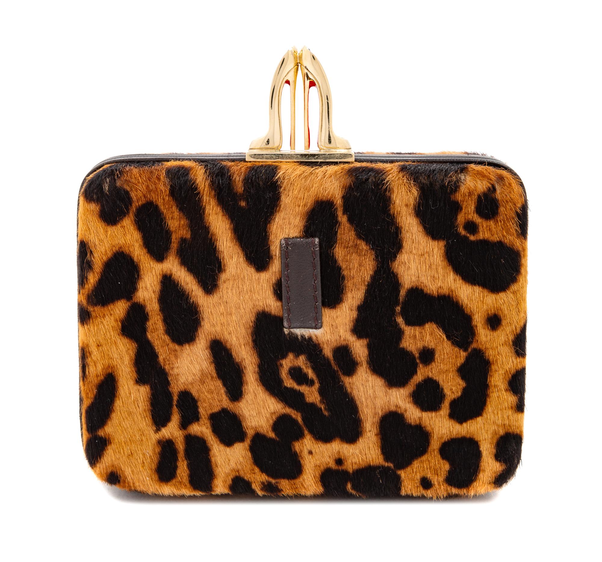 A Christian Louboutin Leopard Print Pony Hair Clutch, 4" H x 5.5" W x 1.5" D.