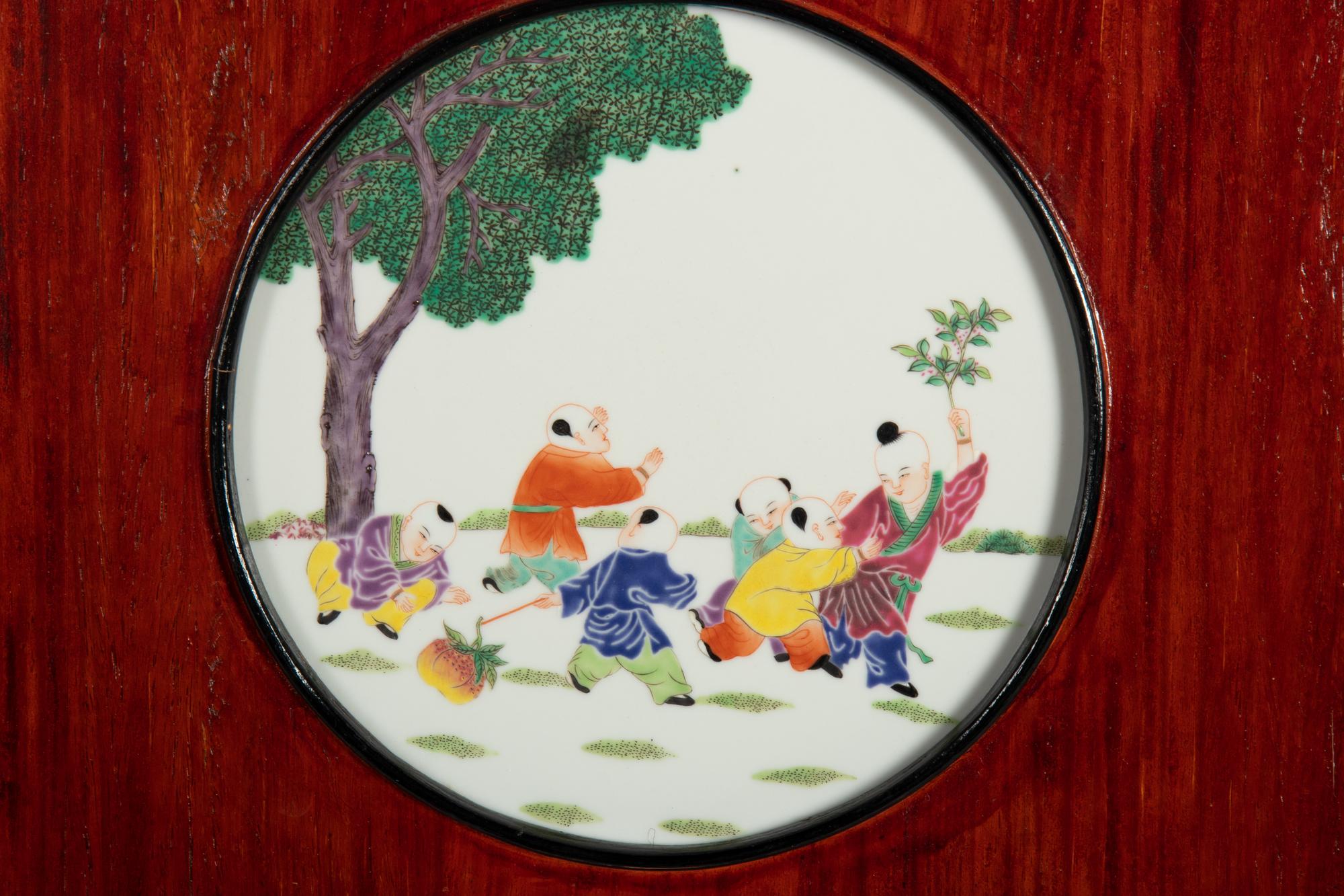 A Set of Four Chinese Famille Rose Porcelain Inset Hardwood Wall Panels