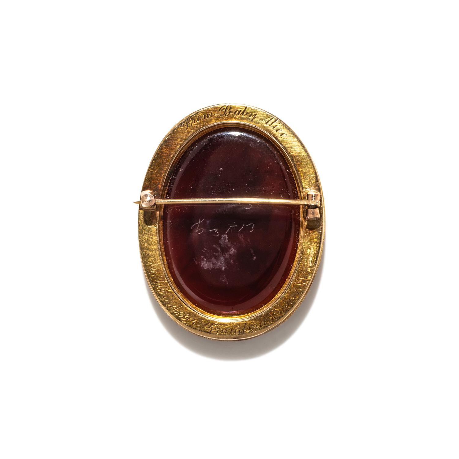 A Neoclassical Gold and Carnelian Brooch with Goddess Venus and Eros
