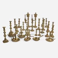 A collection of twenty-one brass candlesticks and lamps Predominately 18th / 19th century