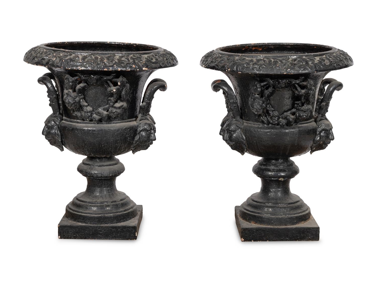 A Pair of Large Cast Iron Campagna-Form Jardinieres on Fossilized Coral Limestone Plinths