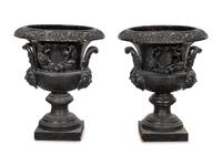 A Pair of Large Cast Iron Campagna-Form Jardinieres on Fossilized Coral Limestone Plinths