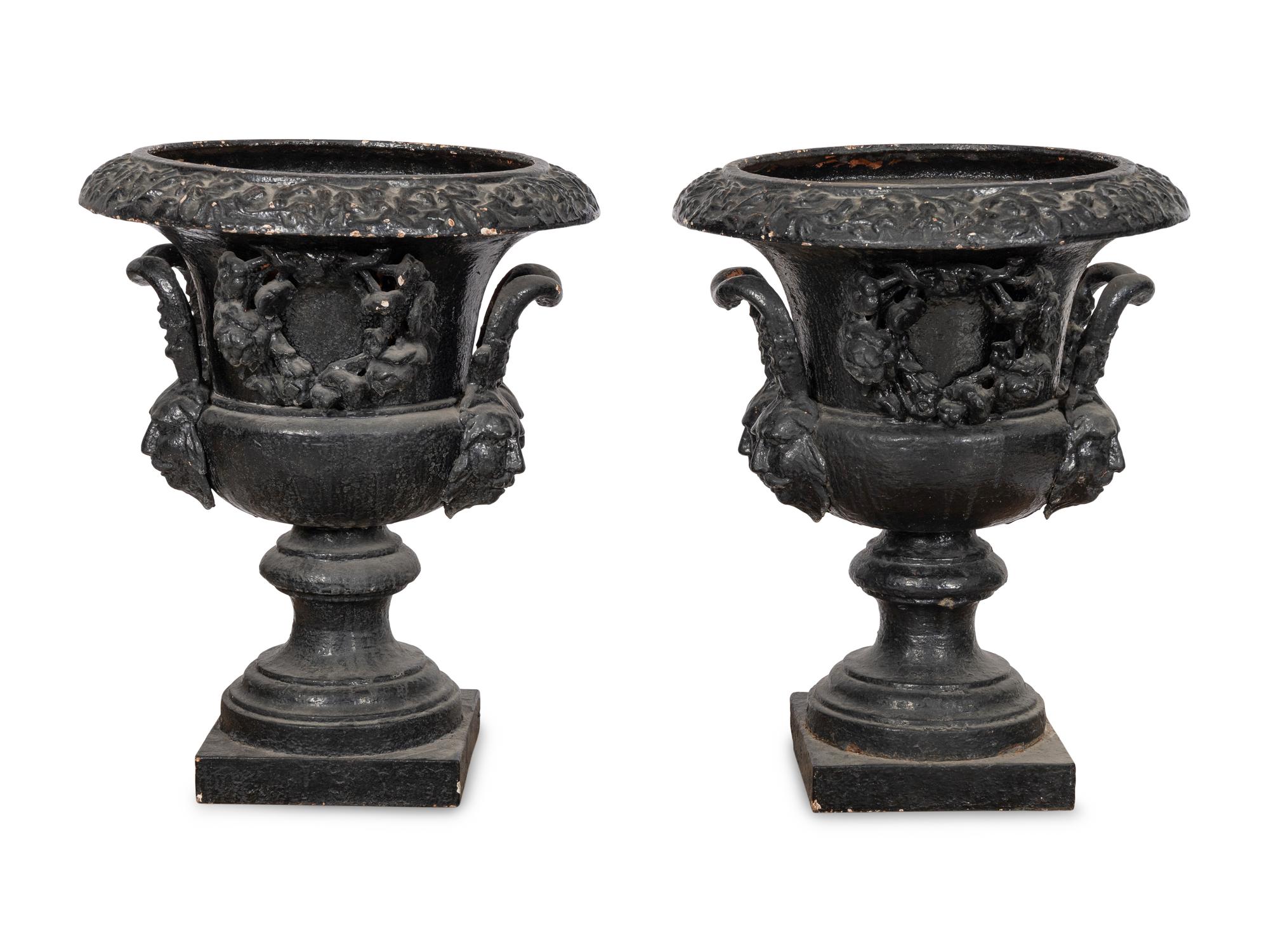 A Pair of Large Cast Iron Campagna-Form Jardinieres on Fossilized Coral Limestone Plinths