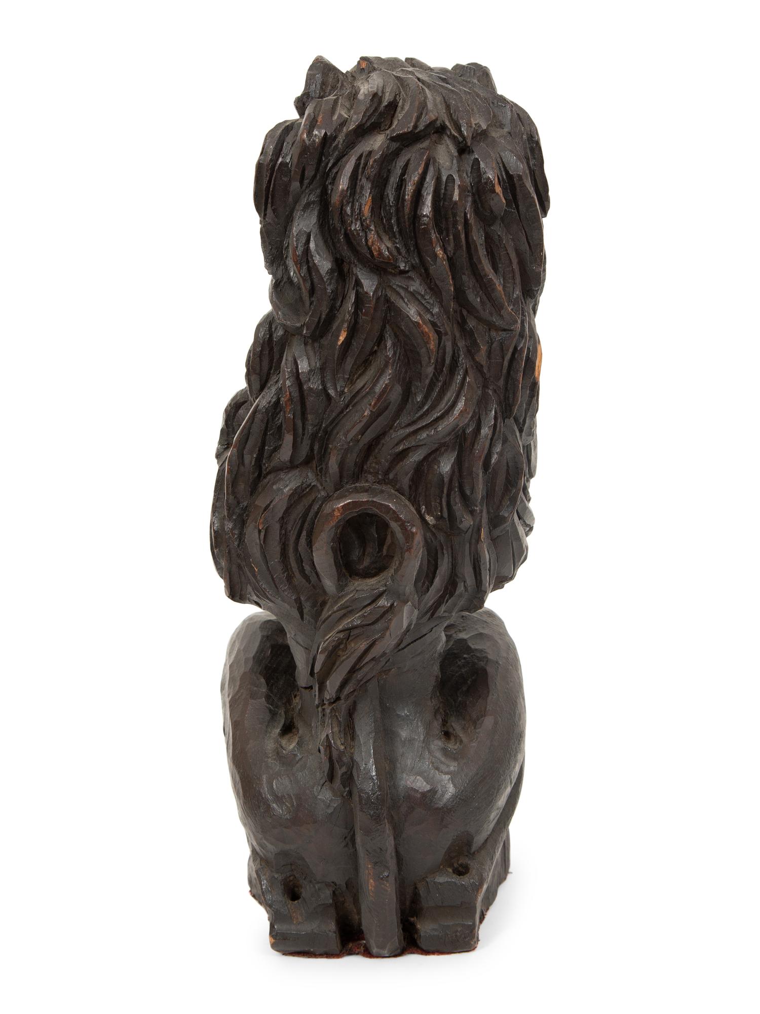 An English Carved and Stained Oak Figure of a Lion
