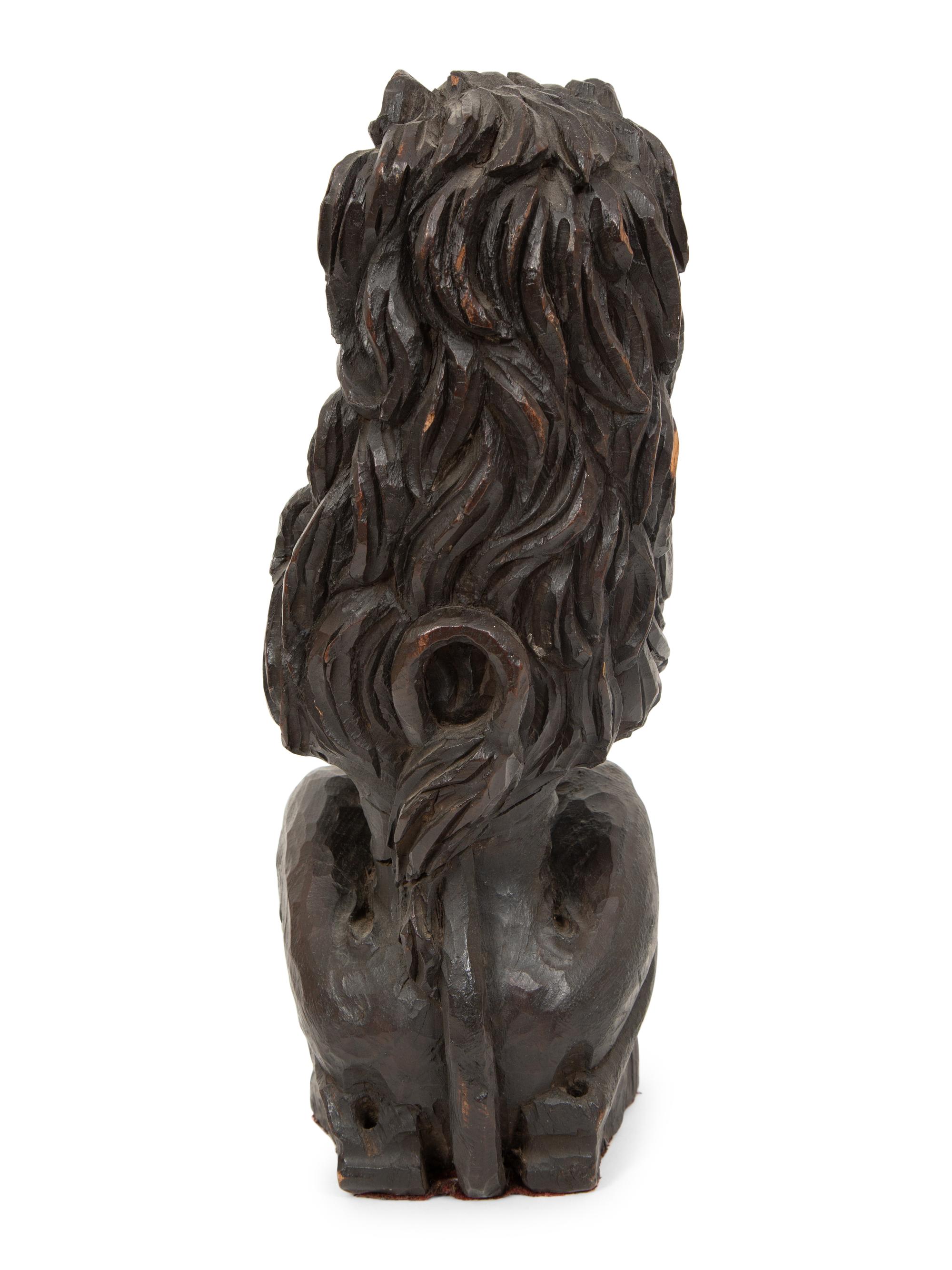 An English Carved and Stained Oak Figure of a Lion