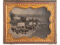 [EARLY PHOTOGRAPHY]. Ambrotype of seven ox-drawn wagons on a road, possibly in Nebraska City, NE. Ca 1859.