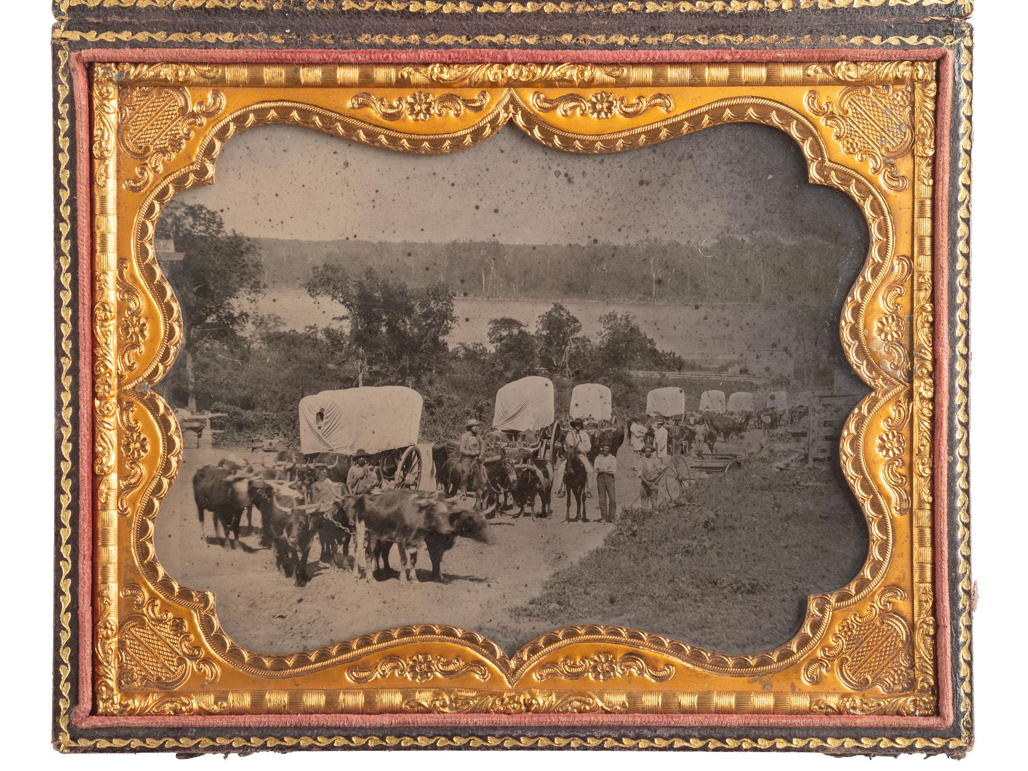 [EARLY PHOTOGRAPHY]. Ambrotype of seven ox-drawn wagons on a road, possibly in Nebraska City, NE. Ca 1859.