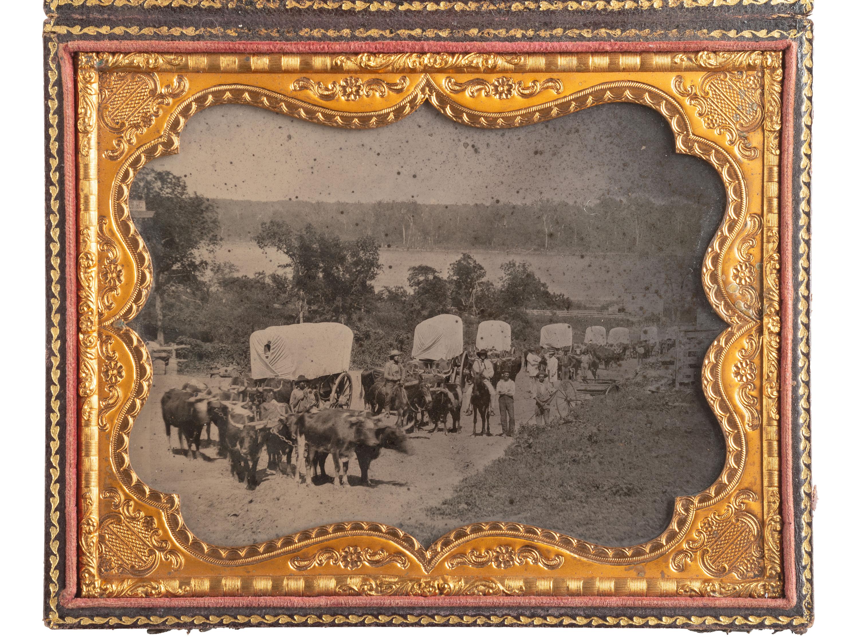 [EARLY PHOTOGRAPHY]. Ambrotype of seven ox-drawn wagons on a road, possibly in Nebraska City, NE. Ca 1859.