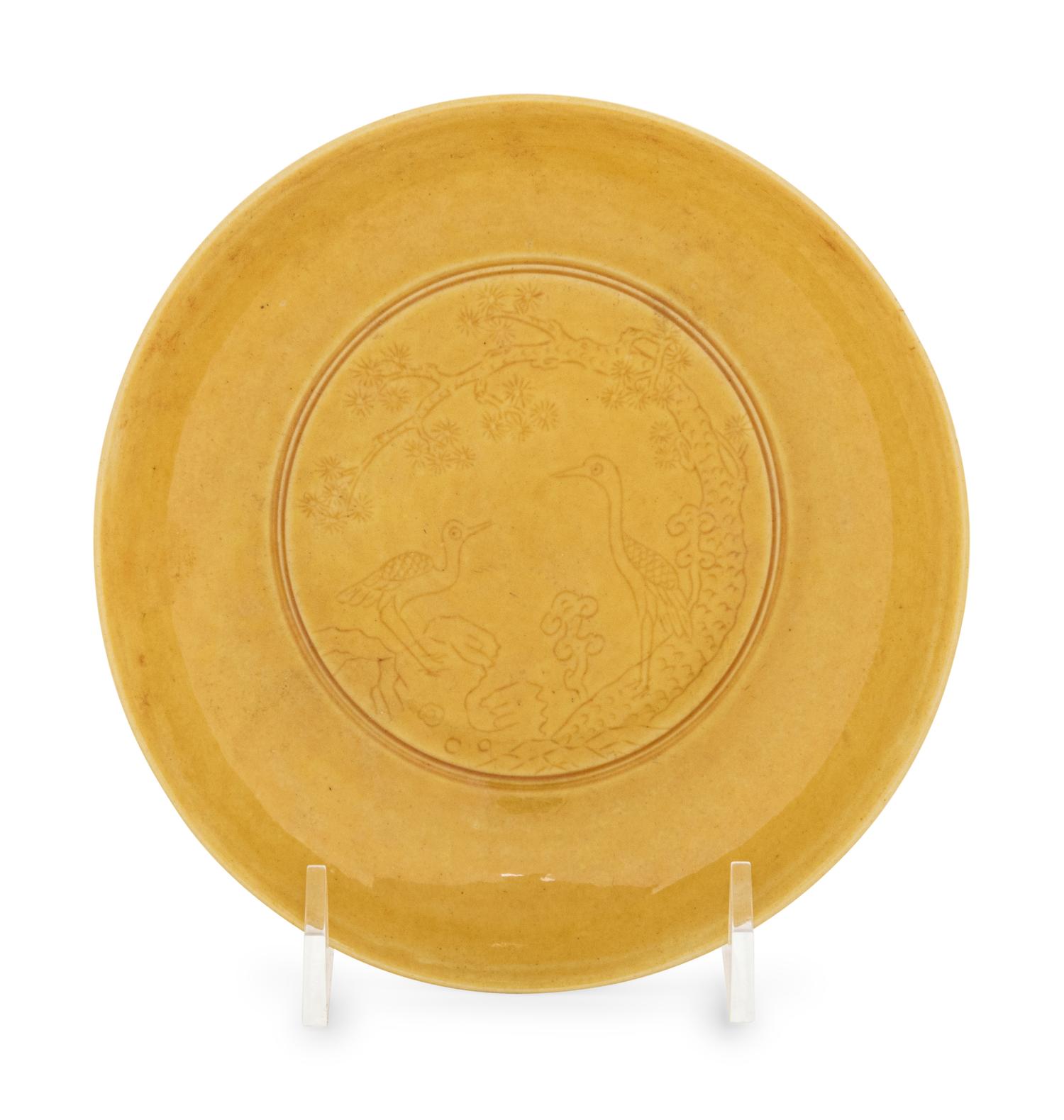 An Incised Yellow Glazed Porcelain 'Cranes and Pines' Plate