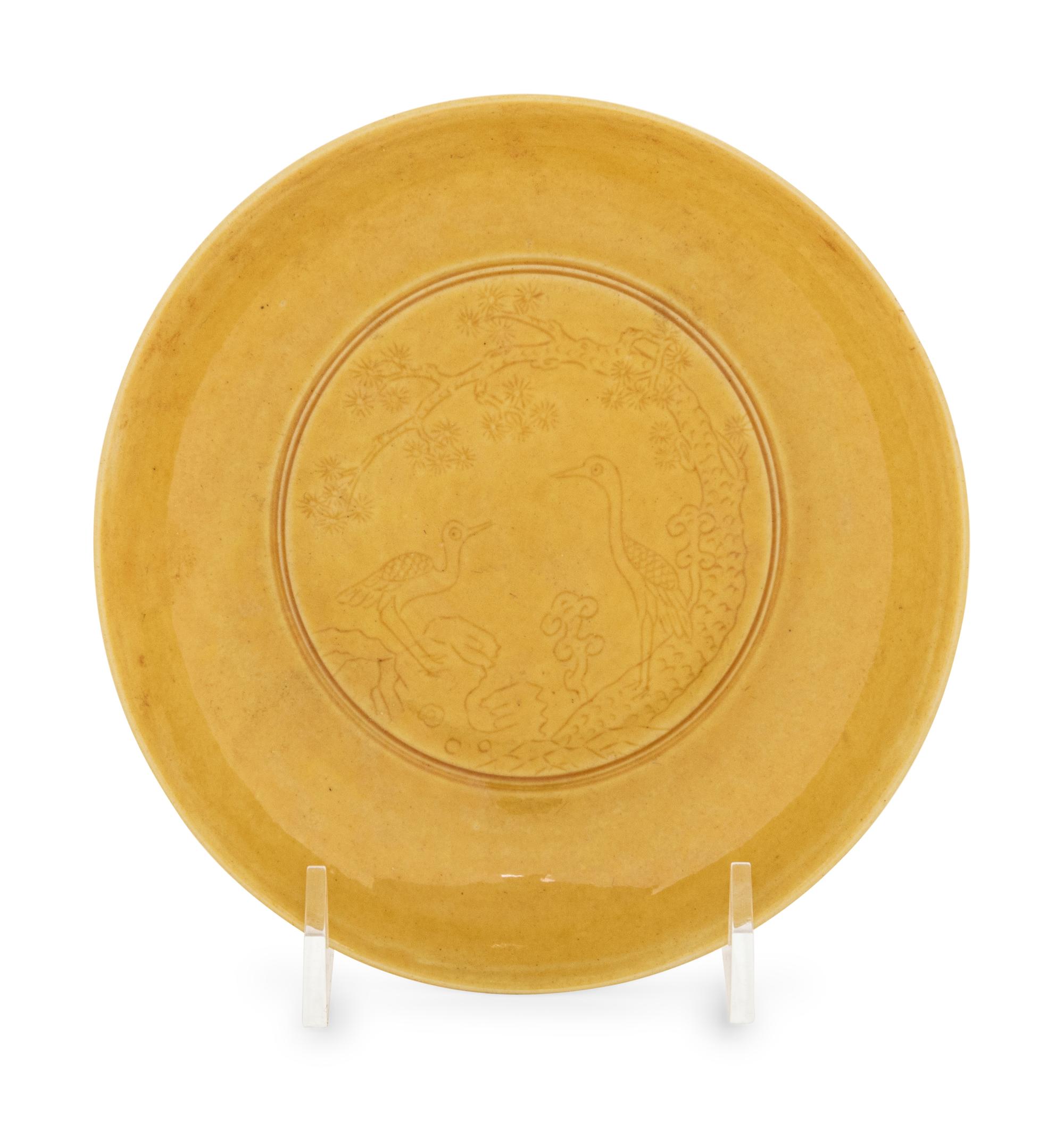 An Incised Yellow Glazed Porcelain 'Cranes and Pines' Plate