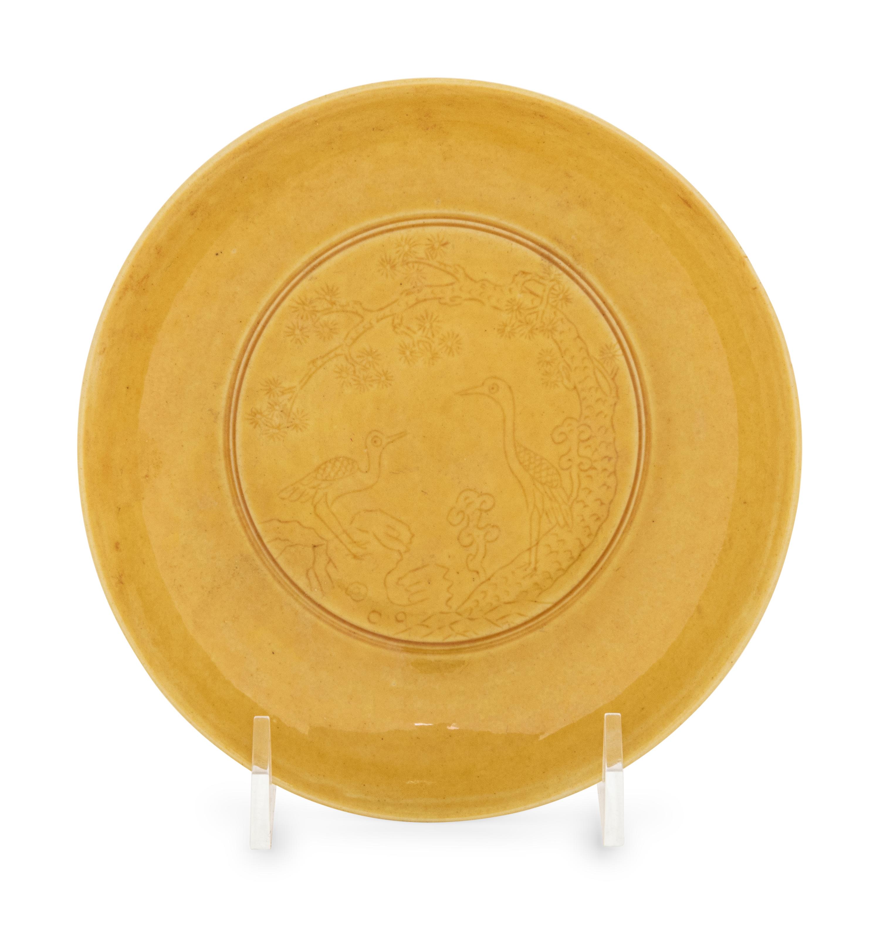 An Incised Yellow Glazed Porcelain 'Cranes and Pines' Plate