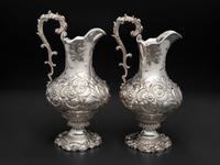 A Pair of American Repousse Silver Presentation Pitchers
