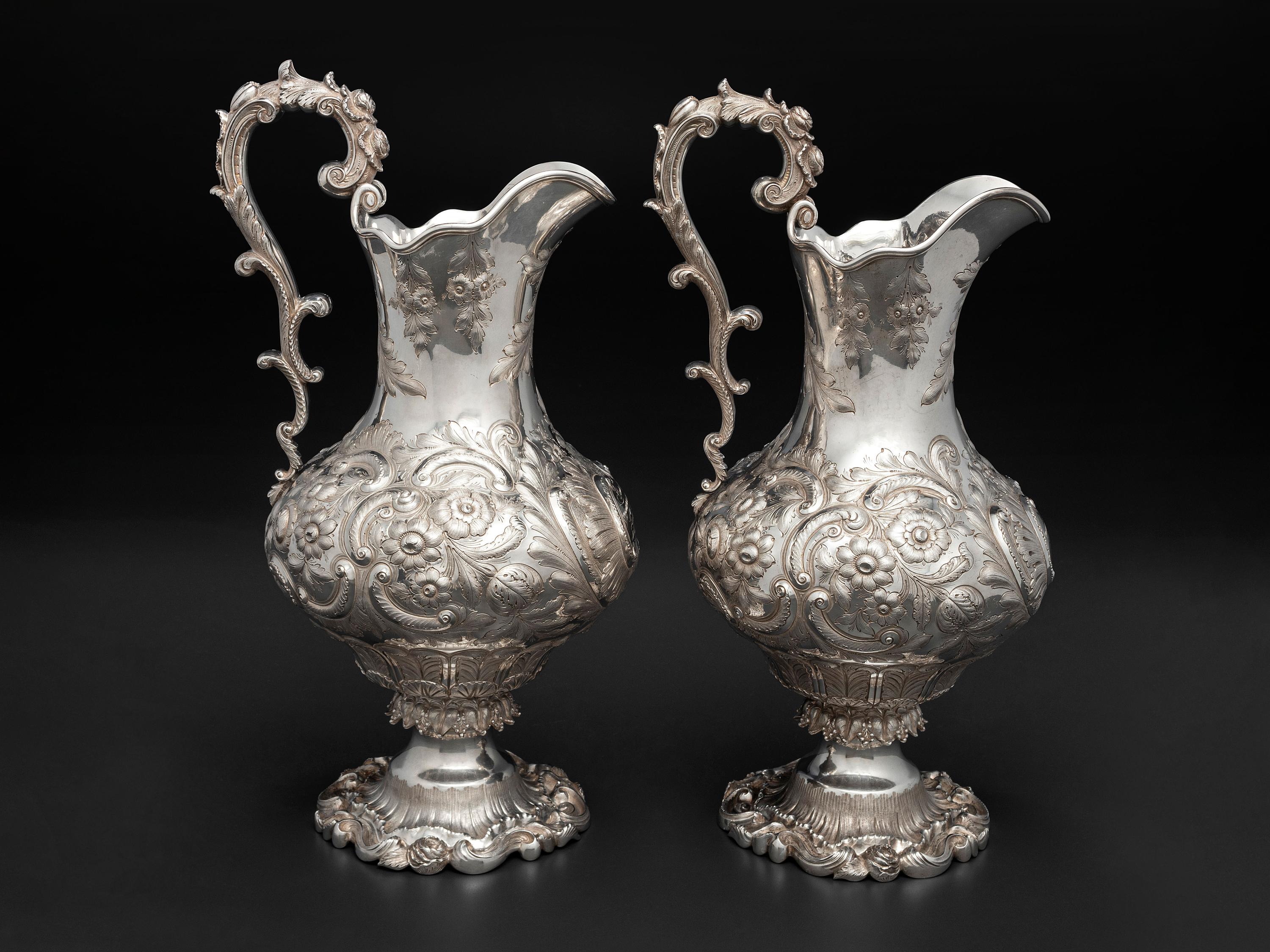 A Pair of American Repousse Silver Presentation Pitchers