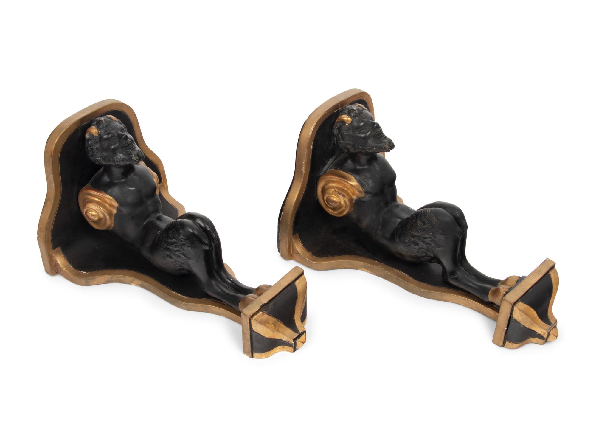 A Pair of Continental Ebonized and Parcel Gilt Wood Figural Brackets