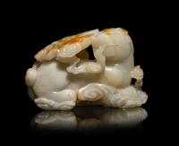 A Chinese Russet and White Jade Carving of a Mythical Beast