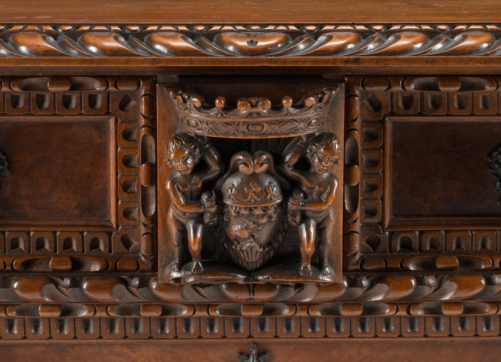 An Italian Renaissance Revival Carved Walnut Chest of Drawers
