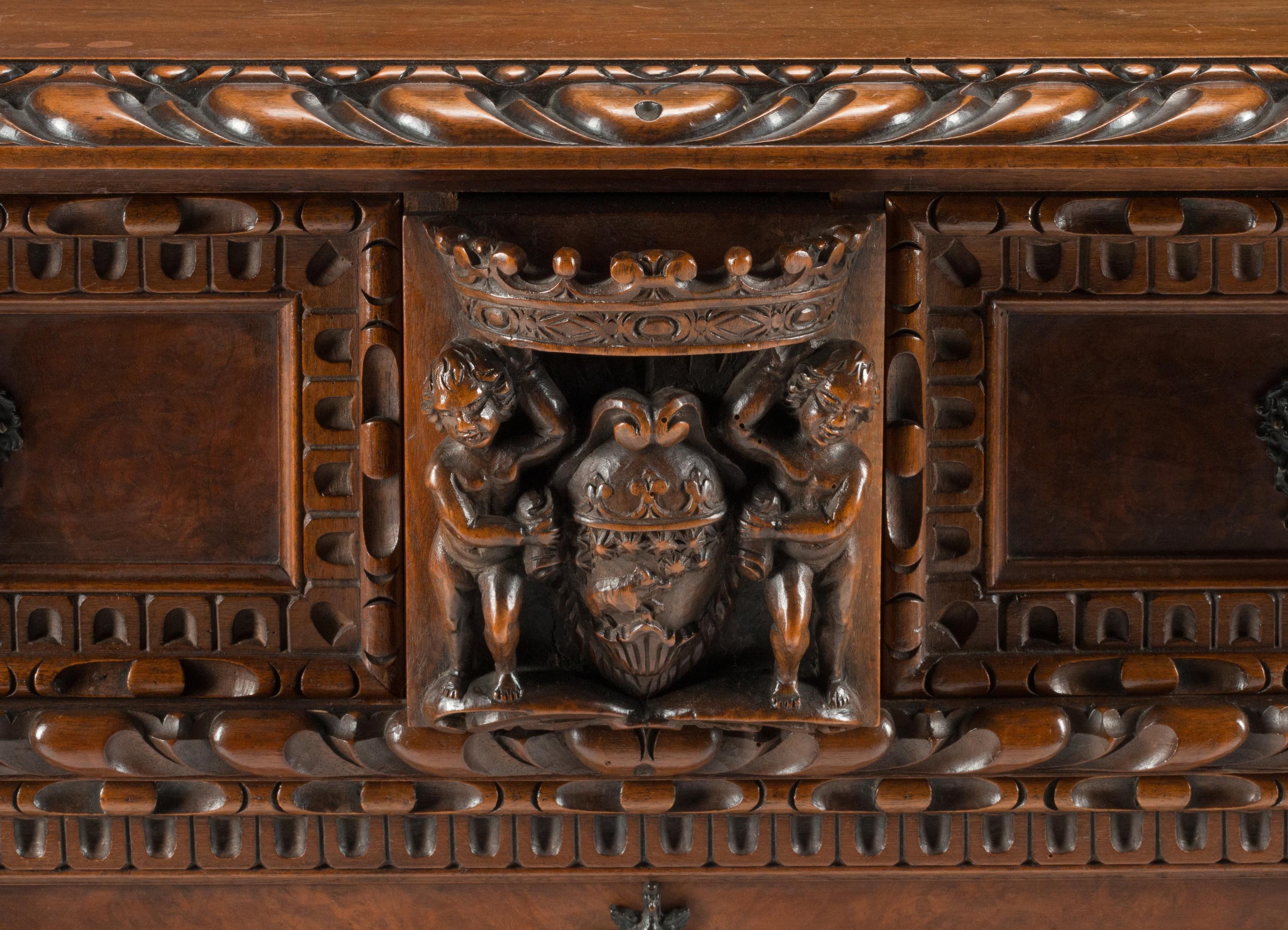 An Italian Renaissance Revival Carved Walnut Chest of Drawers
