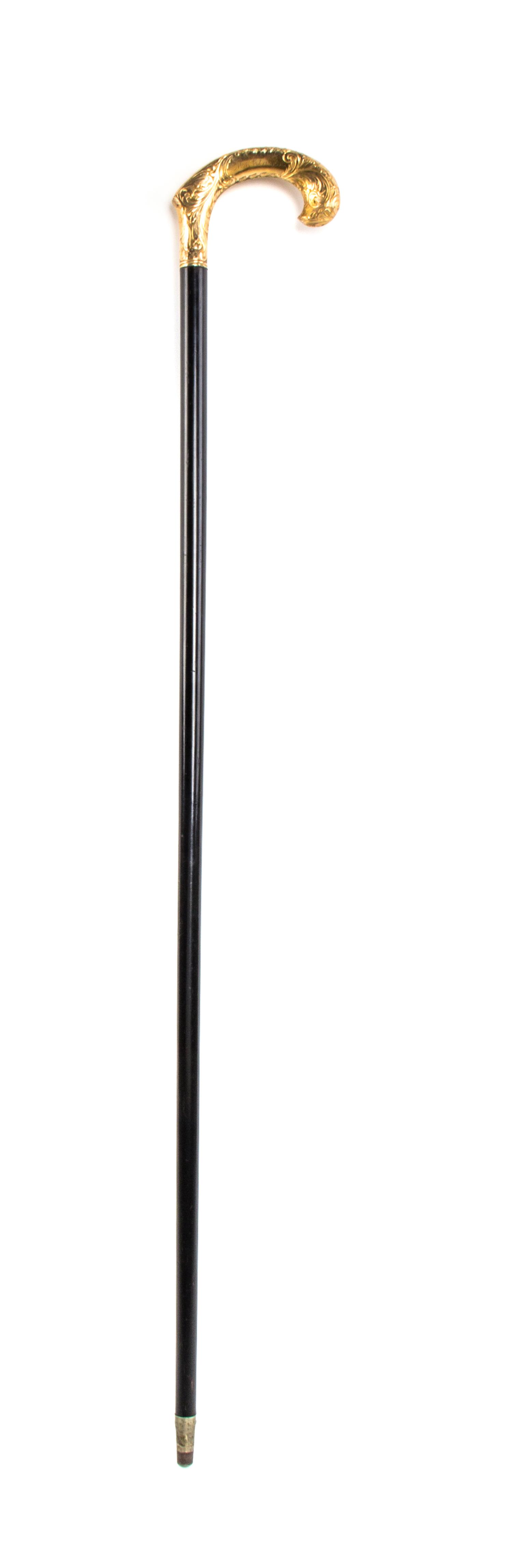 An American Chased Gold Handled Cane, Redlich & Co., Width of handle 4 3/4 x length overall 36 1/4 inches.