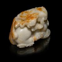A Chinese Russet and White Jade Carving of a Mythical Beast