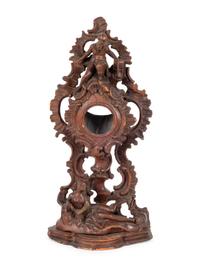 A Continental Rococo Style Carved Fruitwood Watch Stand