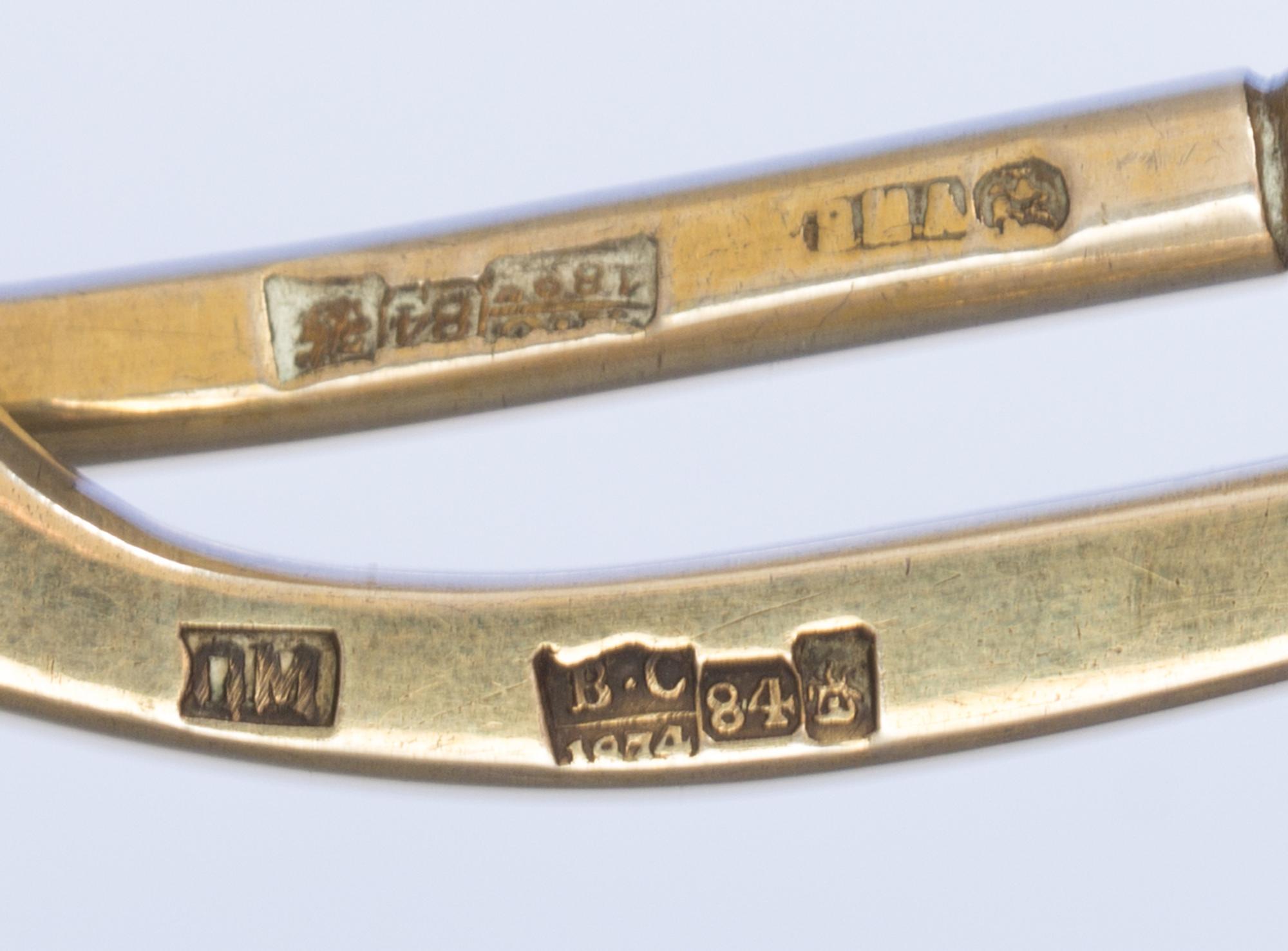 Two Russian Silver-Gilt and Niello Spoons, Various makers, Moscow, 19th century, each having a twist handle, the underside of the bowls