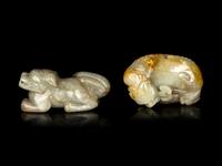 Two Chinese Pale Celadon Jade Figures of Recumbent Beasts