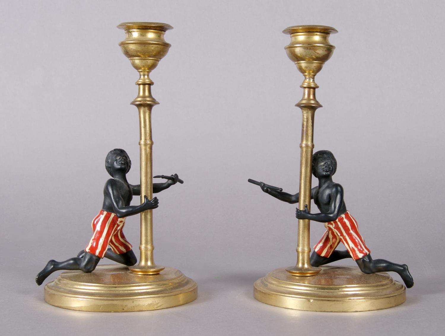 A Pair of Blackamoor Candlesticks, Height 7 1/4 inches.