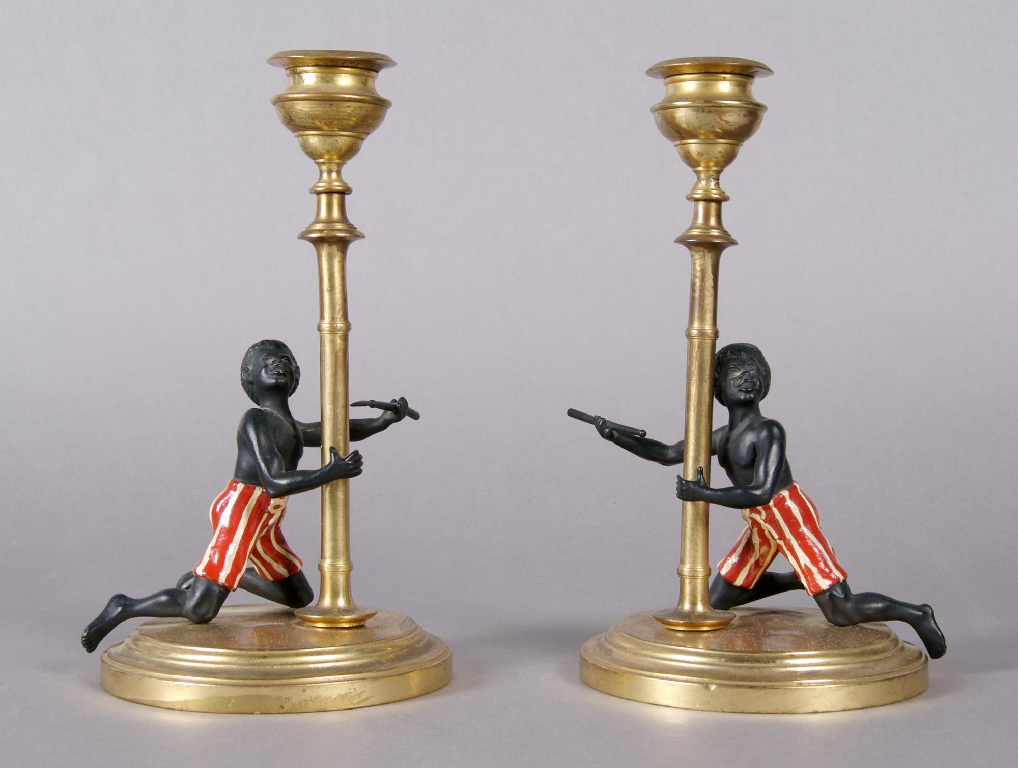 A Pair of Blackamoor Candlesticks, Height 7 1/4 inches.