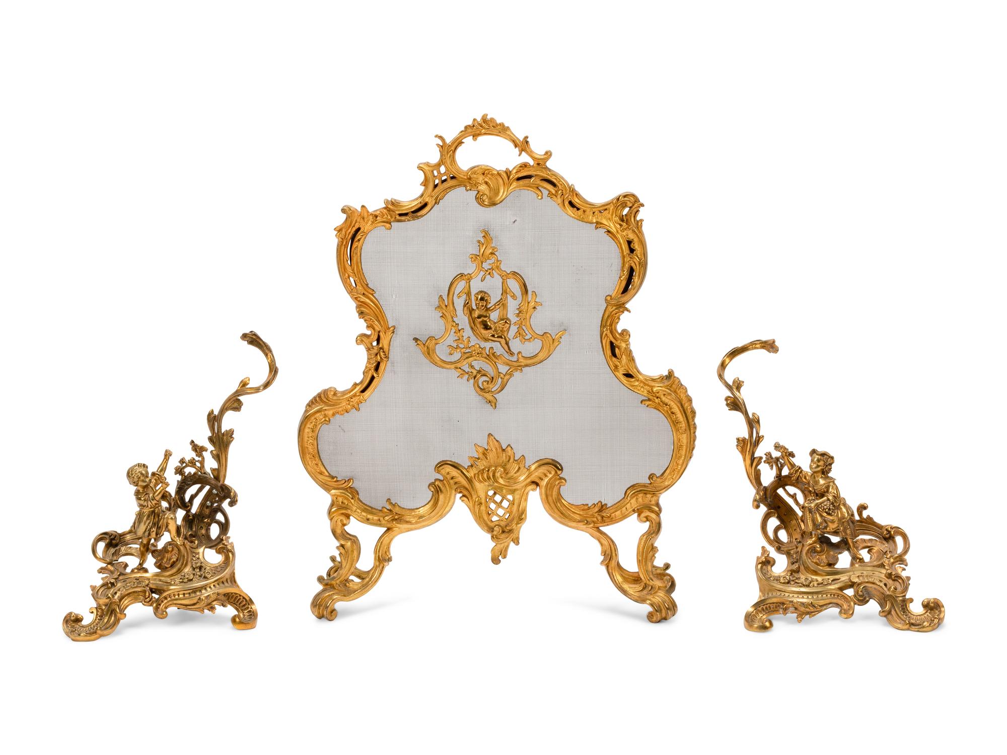A Pair of Louis XV Style Gilt Bronze Chenets and a Similar Fire Screen