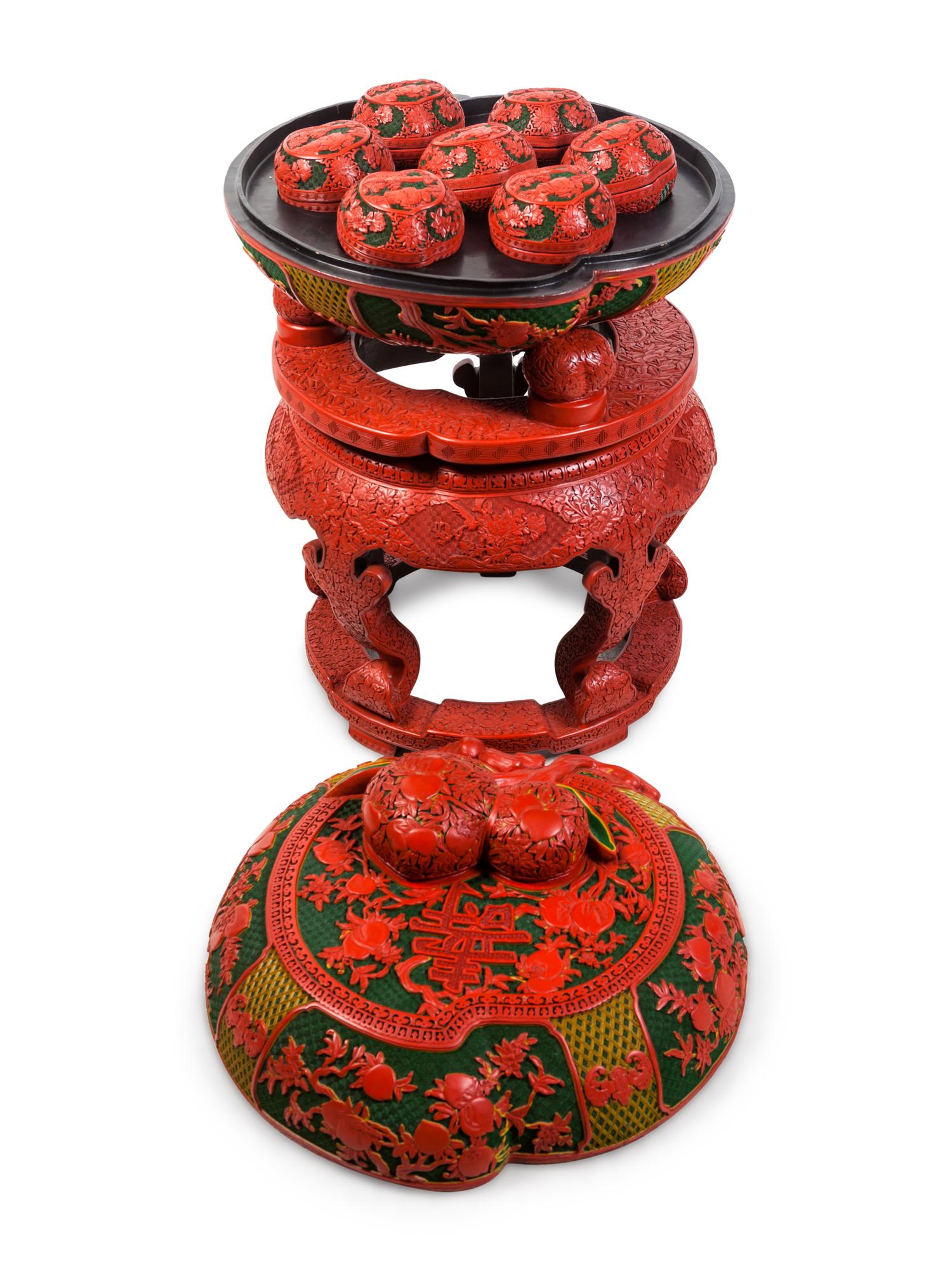 A Set of Chinese Export Carved Red Lacquer "Peach" Nesting Boxes and a Stand
