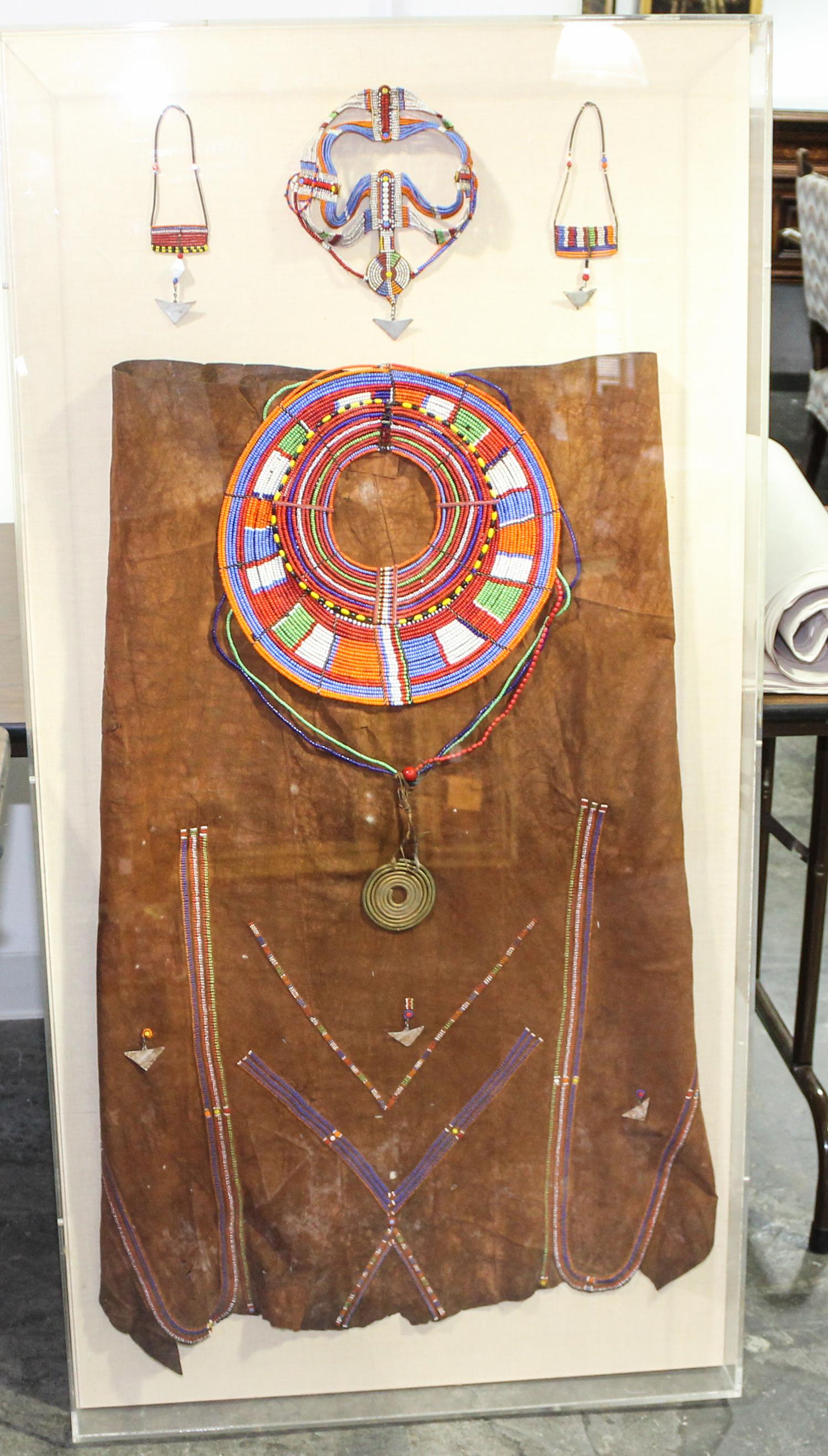 A Framed Group of African Beadwork Articles. Height of frame 55 x width 27 inches.