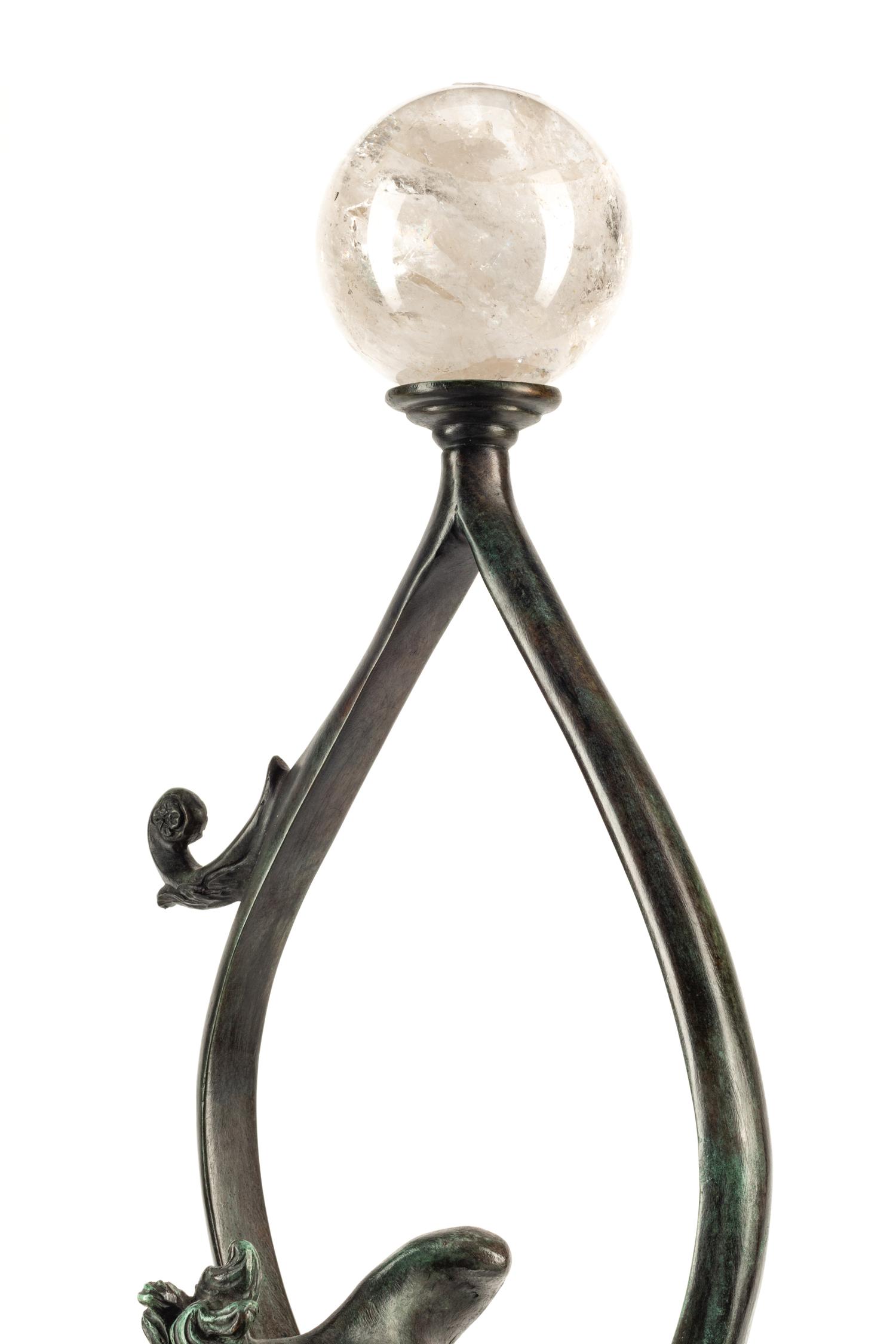 A Continental Patinated Bronze Figure with a Rock Crystal Ornament