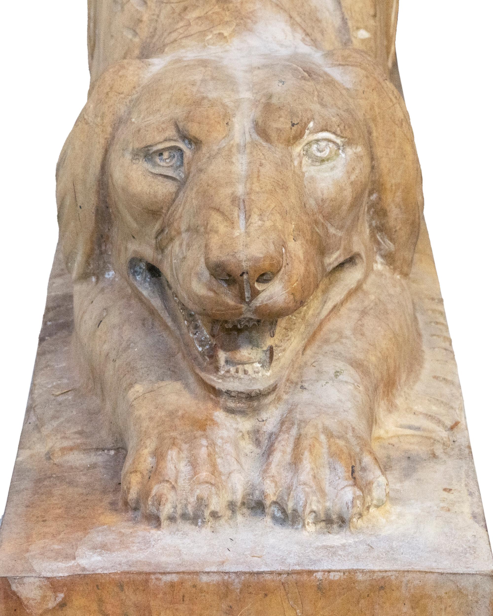 A Pair of Carved Marble Crouching Dogs — 20TH CENTURY