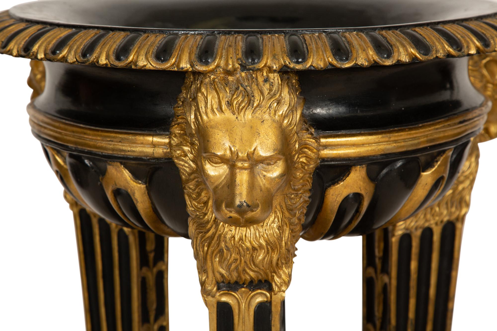 A Pair of Neoclassical Style Ebonized and Parcel Gilt Composition Jardinières on Stands