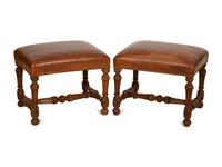 A Pair of Carved Walnut Regence Style Leather Upholstered Stools