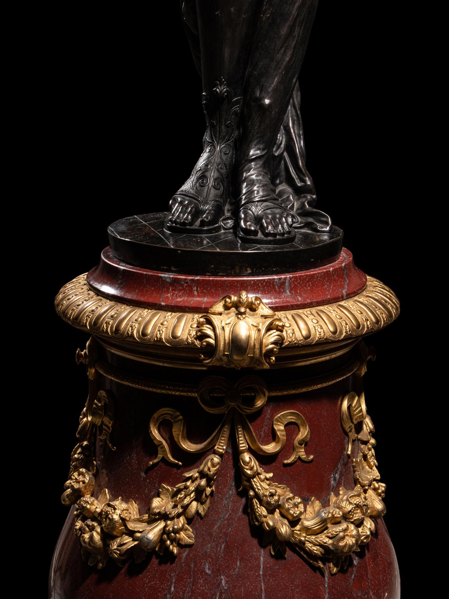 A Pair of Monumental Gilt and Patinated Bronze and Rouge Marble Figural Torchères