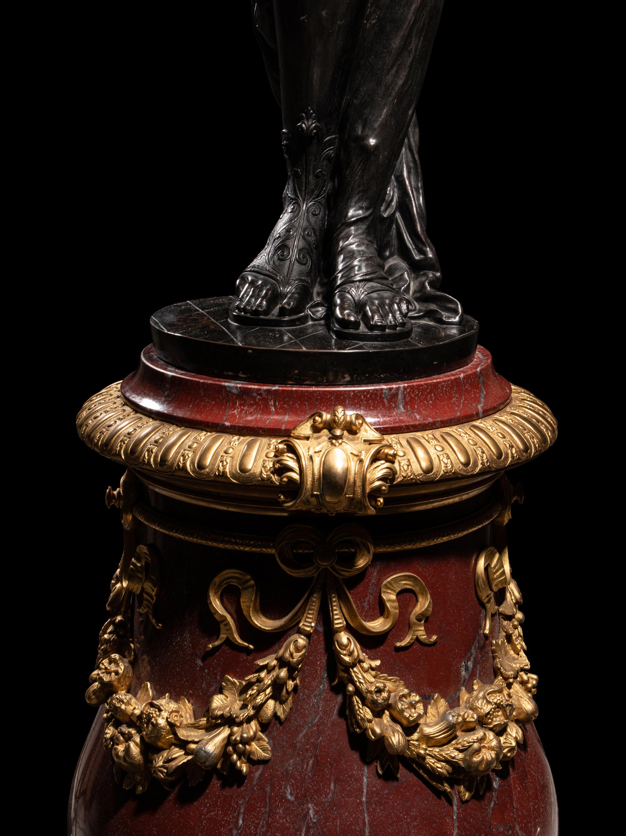 A Pair of Monumental Gilt and Patinated Bronze and Rouge Marble Figural Torchères